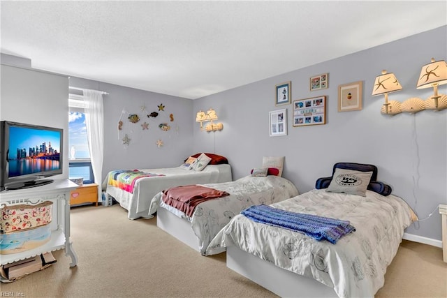 bedroom featuring baseboards, a textured ceiling, and carpet flooring