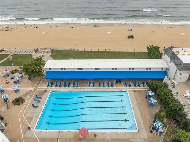 view of pool with a beach view and a water view