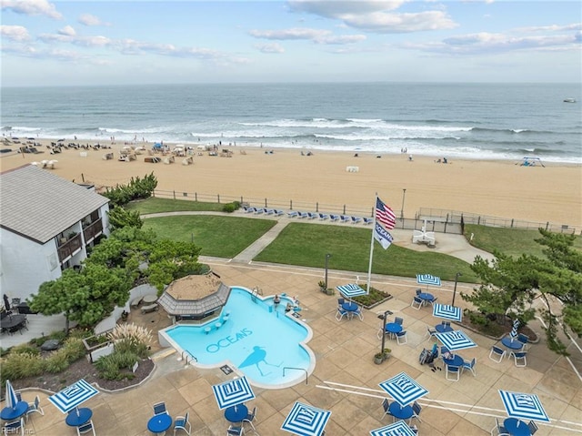 birds eye view of property featuring a beach view and a water view