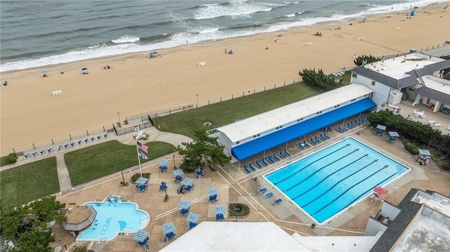 drone / aerial view with a beach view and a water view