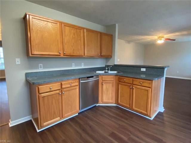 kitchen featuring dishwasher, a peninsula, dark wood finished floors, and a sink