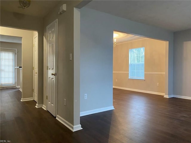 hall with baseboards and dark wood-type flooring