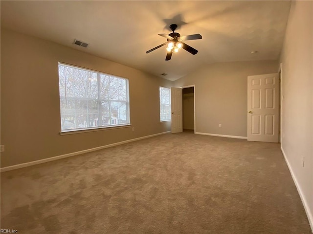 interior space with visible vents, baseboards, carpet, and vaulted ceiling