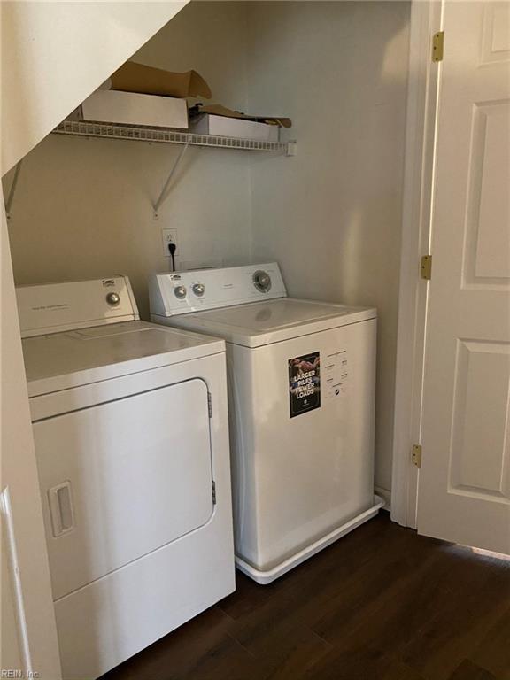 laundry area featuring dark wood-type flooring and washing machine and dryer