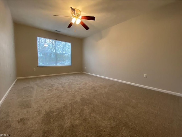 unfurnished room featuring visible vents, baseboards, a ceiling fan, and carpet flooring