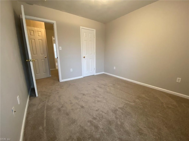 unfurnished bedroom with baseboards and carpet floors