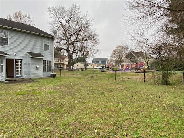 view of yard featuring a playground and fence