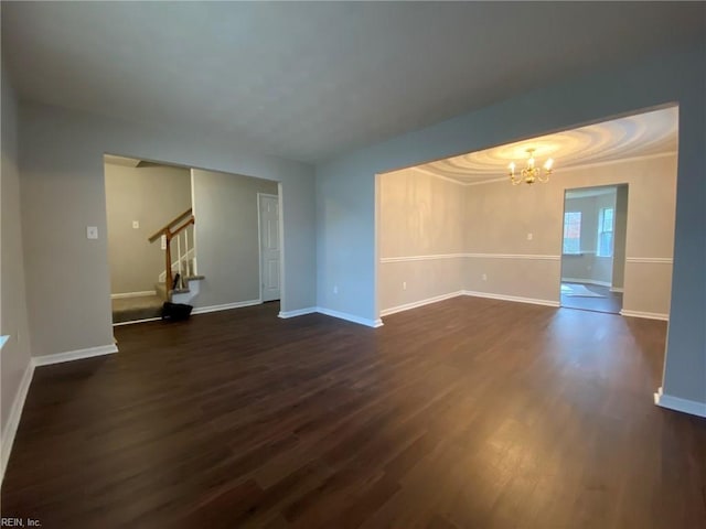 unfurnished room with stairway, baseboards, a chandelier, and dark wood-style flooring