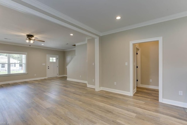 empty room with recessed lighting, light wood-style flooring, crown molding, and baseboards