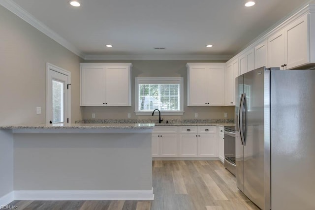 kitchen featuring light stone counters, light wood-style floors, appliances with stainless steel finishes, white cabinets, and crown molding