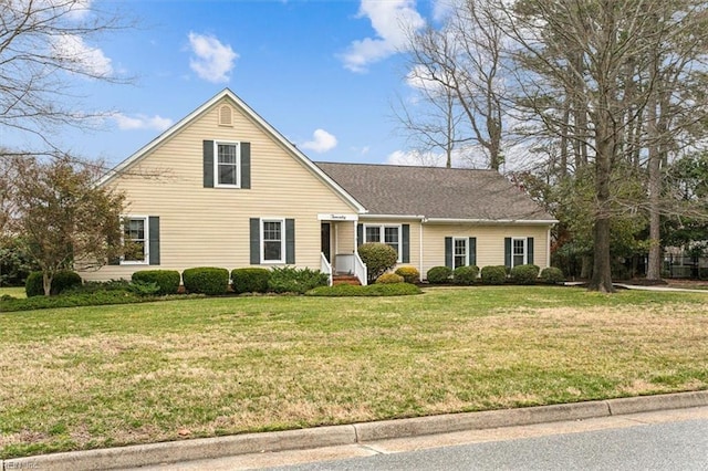 traditional-style home featuring a front lawn