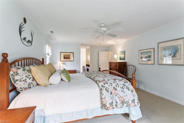 carpeted bedroom featuring visible vents, a ceiling fan, baseboards, and ornamental molding