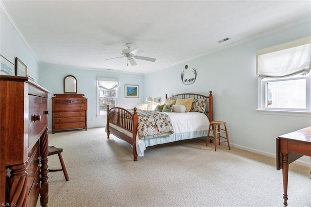 bedroom featuring a ceiling fan, baseboards, visible vents, ornamental molding, and carpet flooring