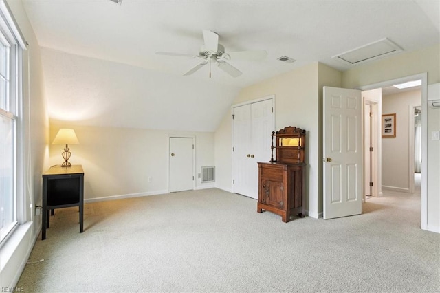 additional living space featuring visible vents, a ceiling fan, and carpet