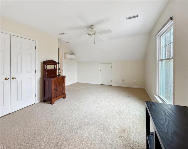 living room featuring a wall unit AC, a ceiling fan, visible vents, and lofted ceiling