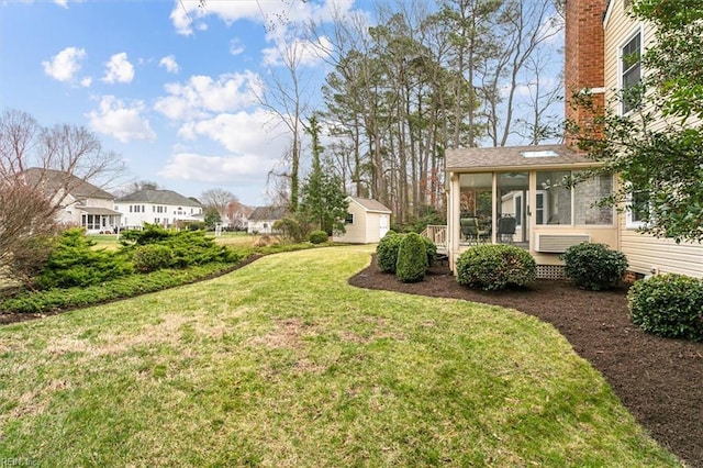 view of yard with an outdoor structure and a sunroom