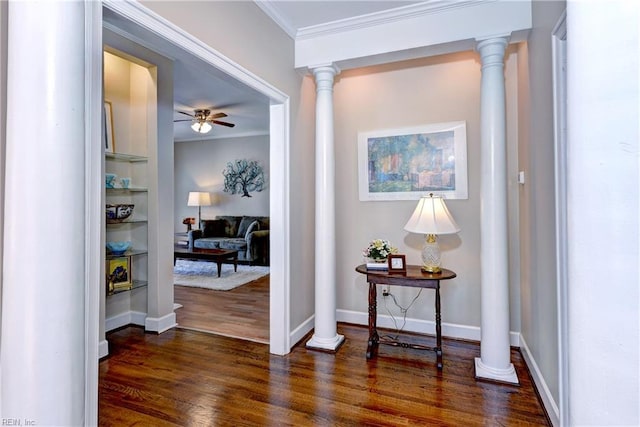 corridor with baseboards, dark wood-type flooring, crown molding, and ornate columns