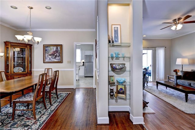 dining room with dark wood finished floors, baseboards, and ornamental molding