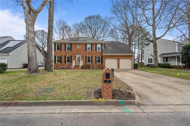 colonial-style house with a garage, a front lawn, brick siding, and driveway