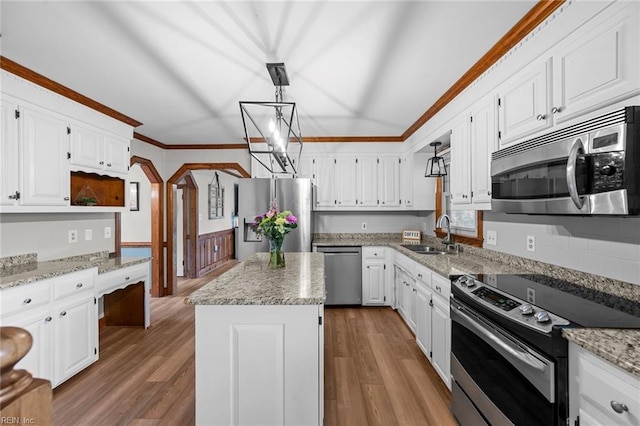 kitchen featuring ornamental molding, appliances with stainless steel finishes, white cabinetry, and a sink