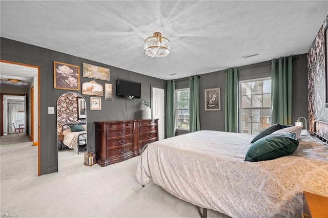 carpeted bedroom featuring visible vents