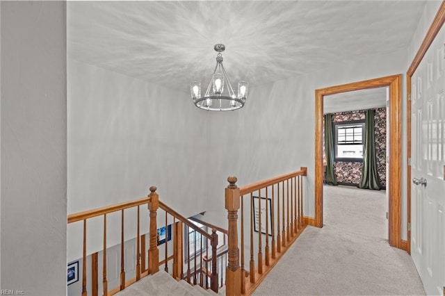 stairway featuring a notable chandelier and carpet floors