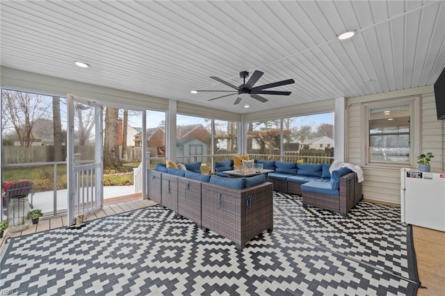 sunroom with plenty of natural light and a ceiling fan