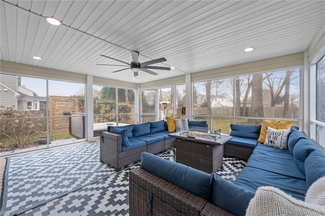 sunroom / solarium featuring a ceiling fan