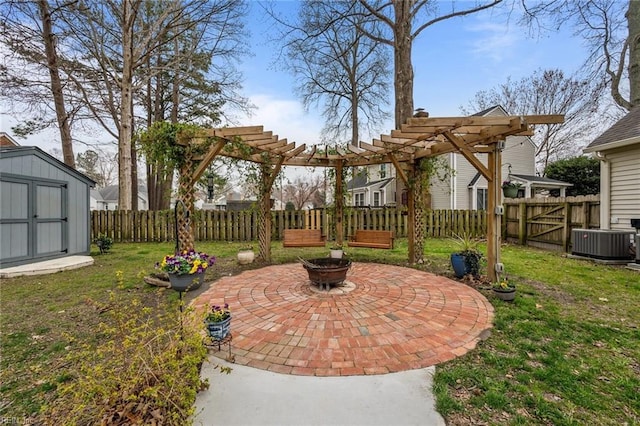 view of patio / terrace featuring fence, a shed, an outdoor fire pit, central AC unit, and a pergola