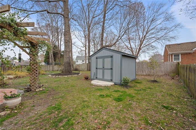 view of yard featuring an outbuilding, a shed, and a fenced backyard