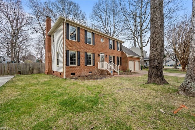 colonial inspired home featuring fence, a front yard, an attached garage, crawl space, and a chimney