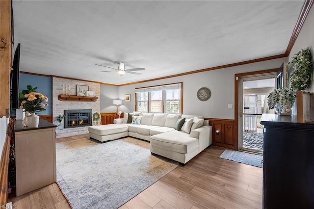 living room featuring a healthy amount of sunlight, a ceiling fan, and light wood finished floors