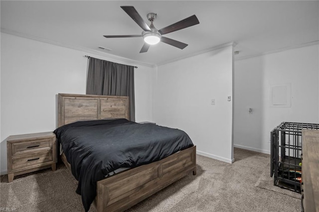 carpeted bedroom with visible vents, ceiling fan, crown molding, and baseboards