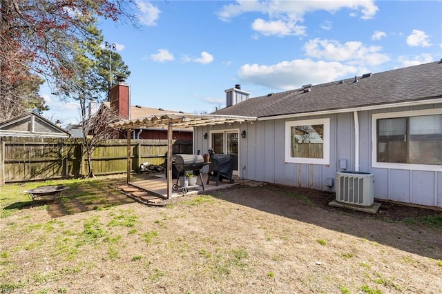 exterior space featuring a pergola, fence, a fire pit, central AC unit, and a patio area