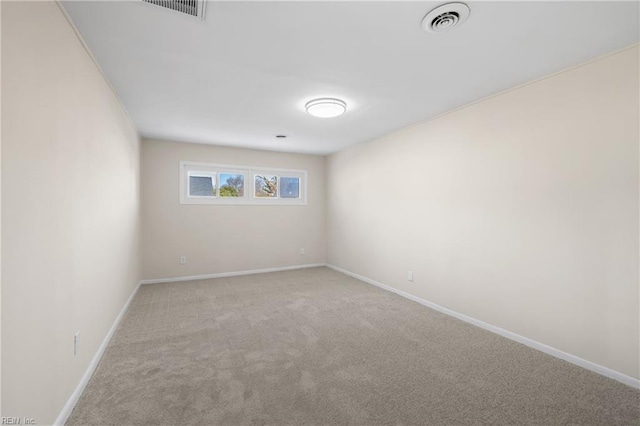 carpeted spare room featuring baseboards and visible vents