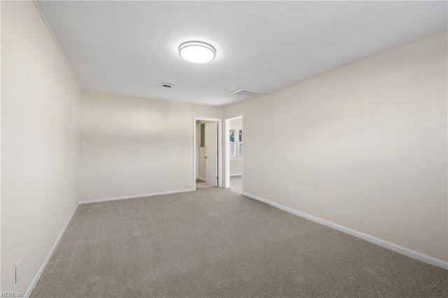 carpeted empty room with baseboards