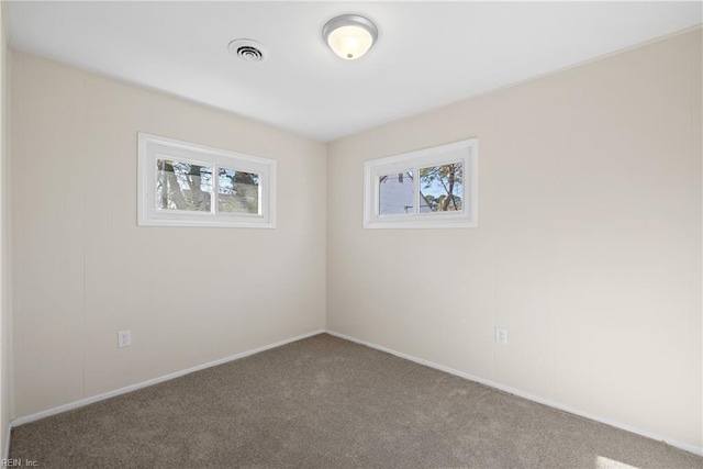 empty room with carpet and visible vents