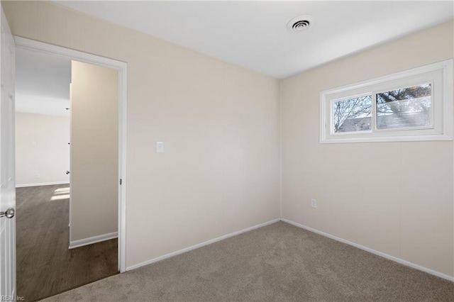 unfurnished bedroom featuring visible vents, baseboards, and carpet