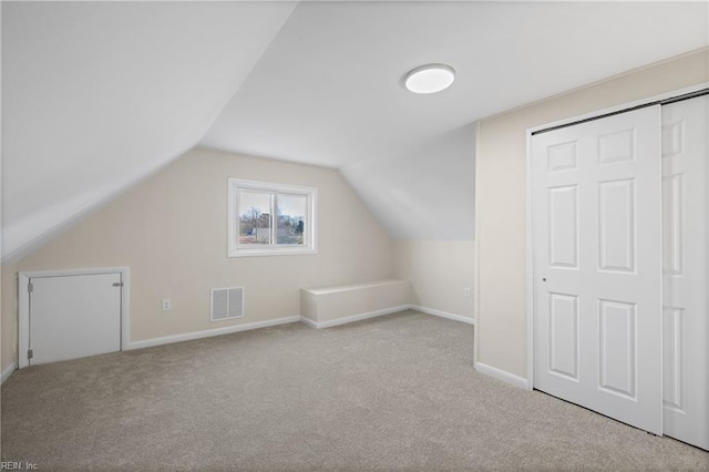 bonus room featuring baseboards, visible vents, carpet floors, and lofted ceiling