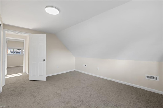 additional living space featuring visible vents, carpet floors, and baseboards