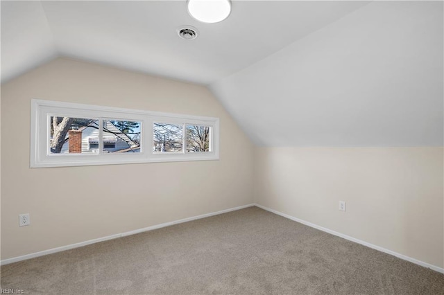 additional living space featuring lofted ceiling, carpet, baseboards, and visible vents