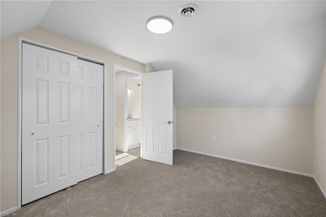 additional living space featuring baseboards, carpet floors, lofted ceiling, and visible vents