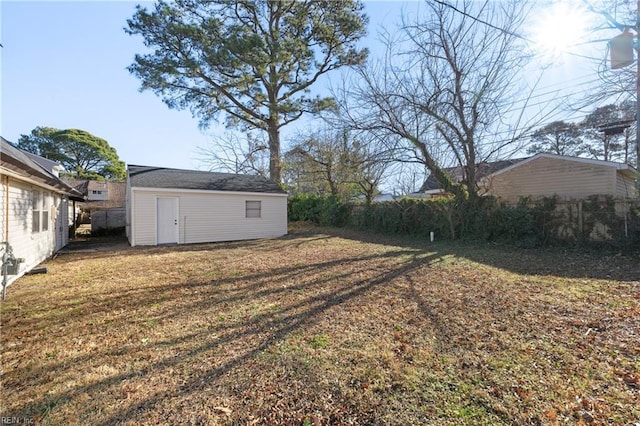 view of yard with an outbuilding and fence