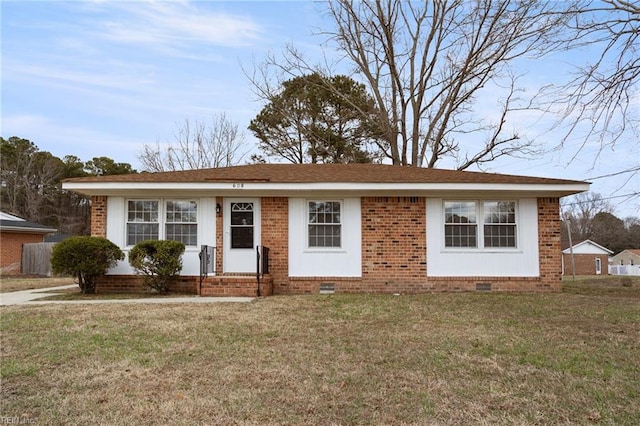 ranch-style home with a shingled roof, a front lawn, brick siding, and crawl space