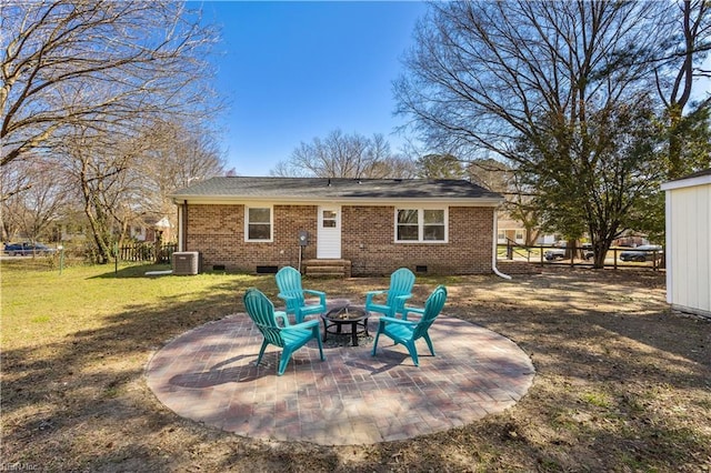 back of property featuring a patio, a trampoline, fence, crawl space, and brick siding