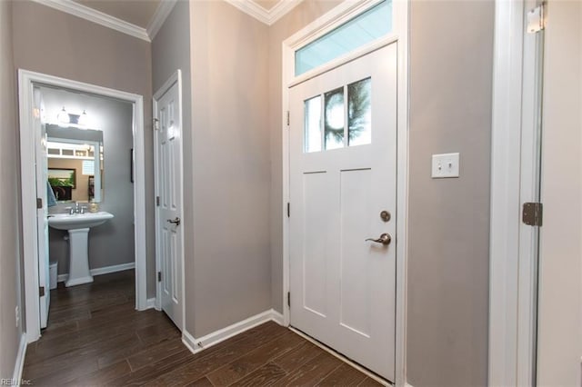 entrance foyer featuring dark wood-style floors, baseboards, and ornamental molding