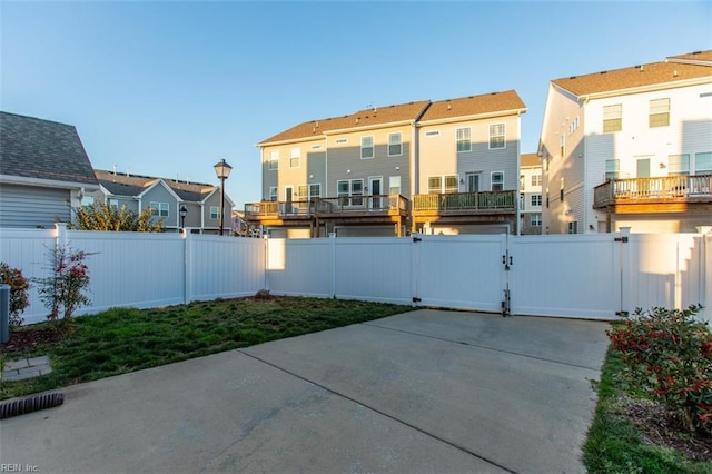 view of patio / terrace featuring a residential view, a fenced backyard, and a gate