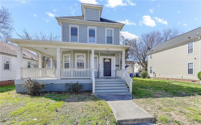 american foursquare style home with a front lawn and covered porch