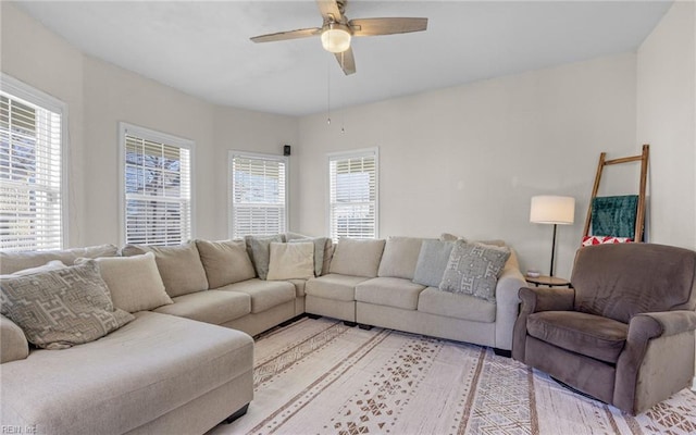 living area with light wood-style flooring and a ceiling fan