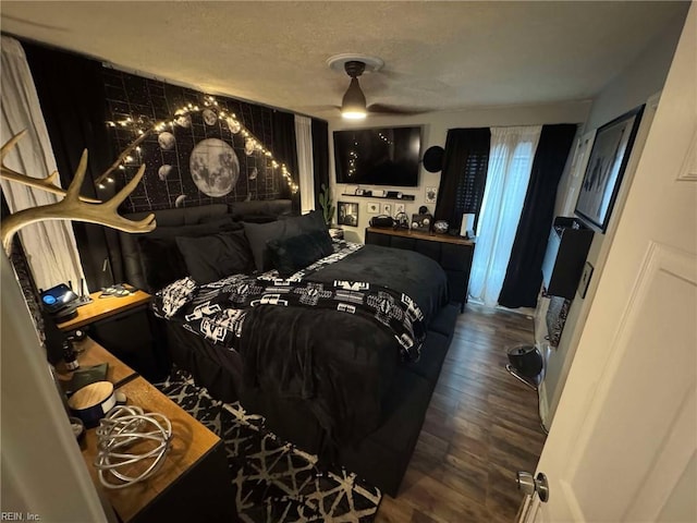 bedroom featuring a textured ceiling and wood finished floors